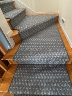 Grey blue patterned stair runner on hardwood stairs
